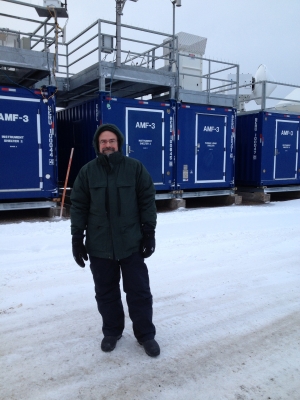 ARM scientist Ed Luke stands in front of the radar and instrument shelters at Oliktok Point, Alaska 