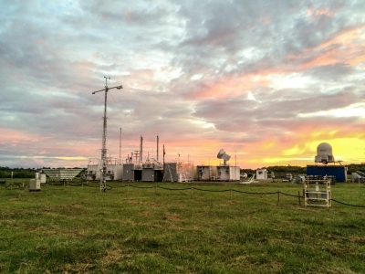 While deployed for GoAmazon2014/15 outside of Manaus, Brazil, the first ARM Mobile Facility is lit up by a sunset.