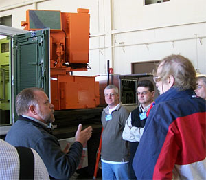 A staff scientist from CIRPAS reviews the unique capabilities provided by the phased-array radar, mounted on the truck behind the group.