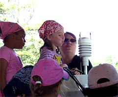 To earn their Weather Badges, Girl Scouts rotated through a variety of learning stations, including one featuring instruments for measuring atmospheric properties. Campers blew air onto the radiation shields surrounding the temperature and humidity sensor to observe any changes recorded by the instrument.