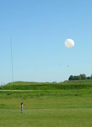 A graduate student from Penn State releases a weather balloon to support the CO2 DIAL field campaign. Soundings are focused on daytime measurements, when sunlight heats the Earth's surface, creating convection and resulting in a well-mixed boundary layer. (Photo credit: Grace Koch, NASA Langley)