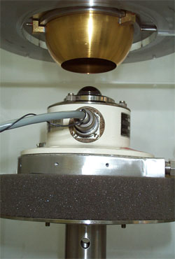 This photo shows a pyrgeometer entering the blackbody calibration chamber.  A blackbody is an object that absorbs all electromagnetic radiation that falls onto it. This lack of both transmission and reflection properties make blackbodies ideal sources for calibrating instruments that measure radiation, like the pyrgeometer.