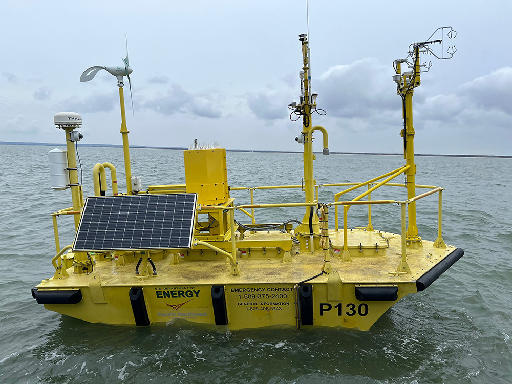 A U.S. Department of Energy lidar buoy, managed by Pacific Northwest National Laboratory, gathers data on wind speed and other atmospheric phenomena during the Wind Forecast Improvement Project-3 (WFIP-3) off the coast of New England. To the right is a flux sensor, installed in cooperation with the University at Albany in New York. Photo is by Matt Brooking, University at Albany.