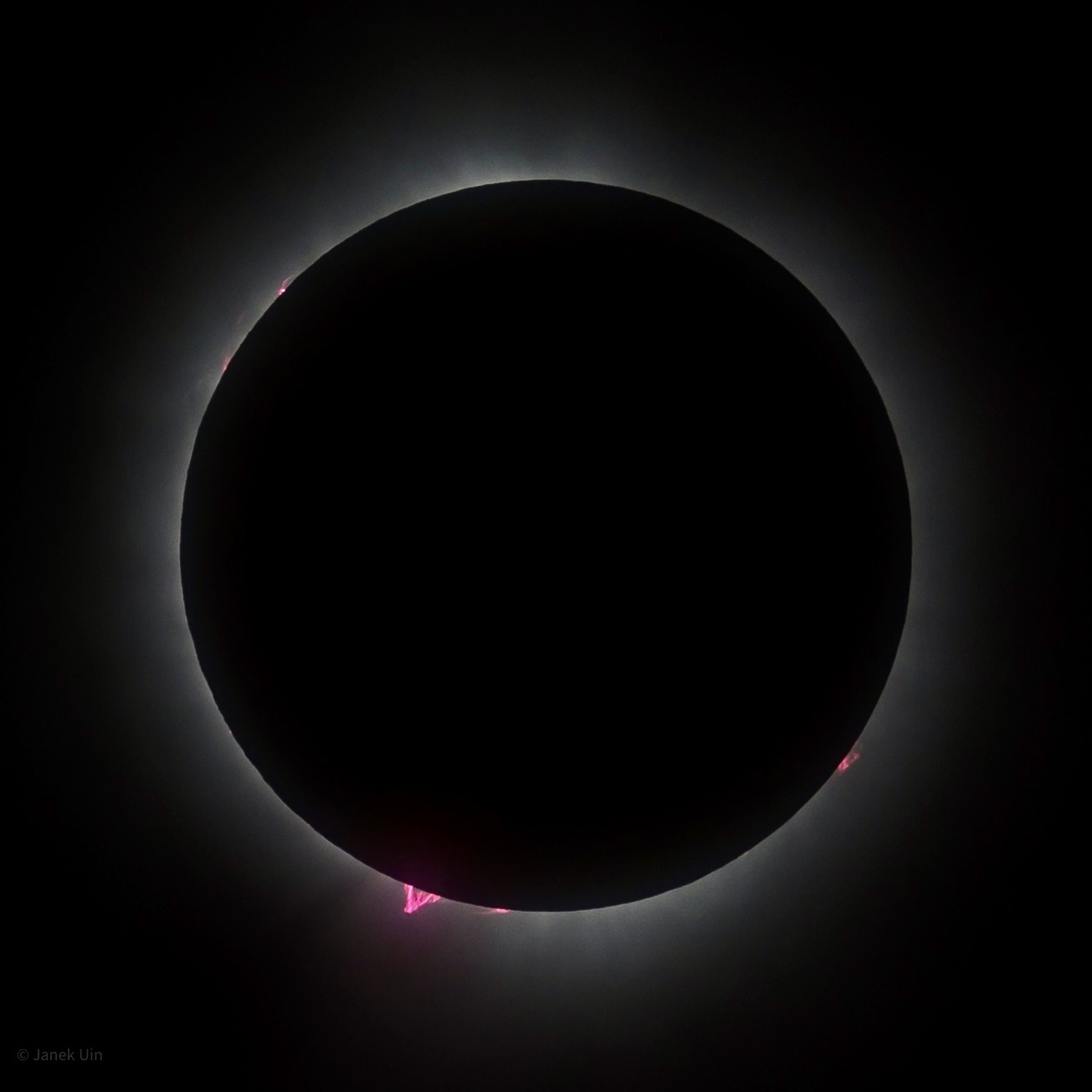 Janek Uin, an ARM aerosol instrument mentor at Brookhaven National Laboratory, took this 2024 eclipse photo in the path of totality by Durant Lake in the Adirondack Mountains of upstate New York. The photo captures several pink bursts, which are called solar prominences. NASA defines a solar prominence as “a large, bright feature extending outward from the sun’s surface.”