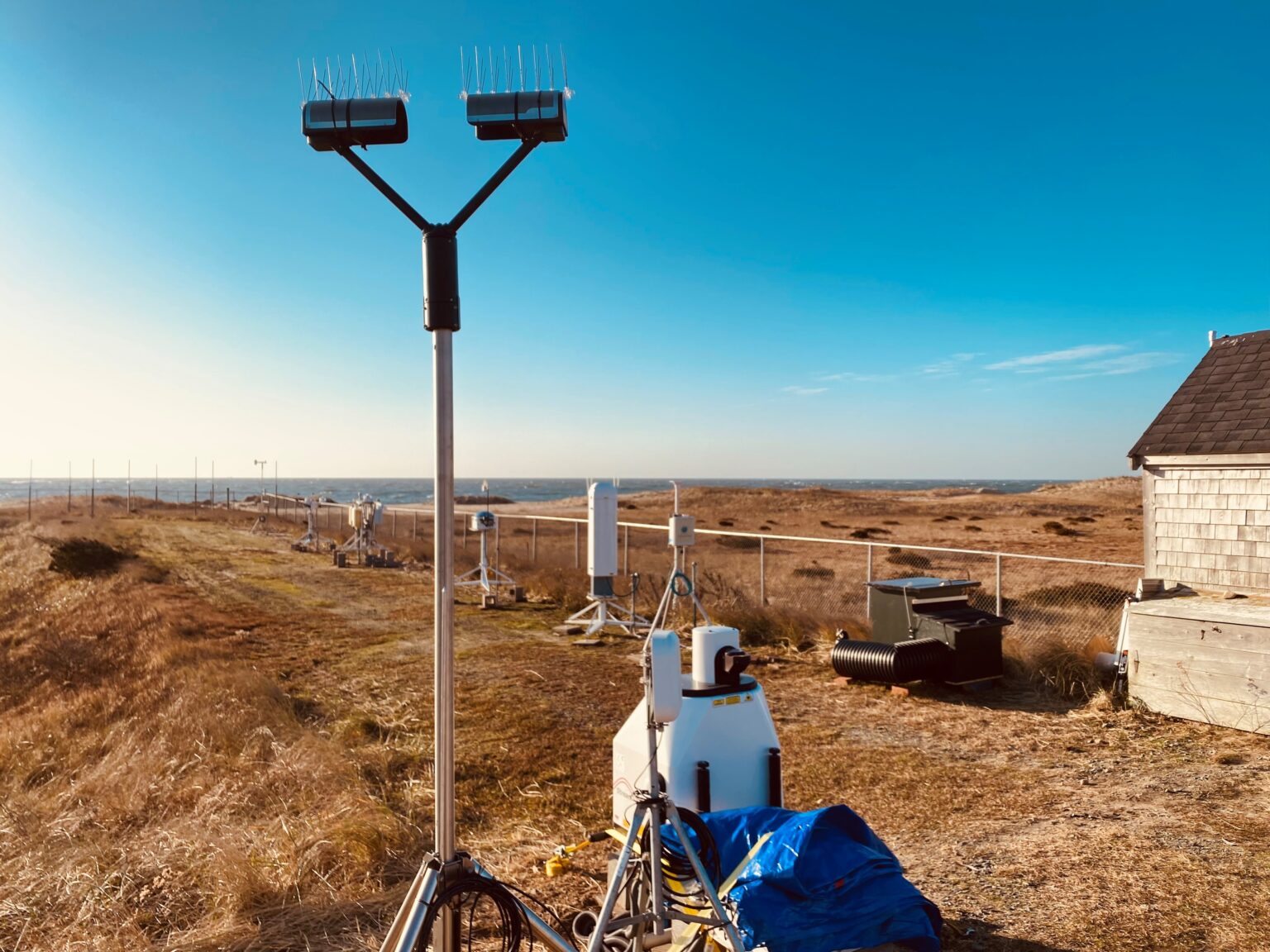 A set of instruments is installed on a patch of land near the ocean.