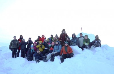 Watershed School's bundled-up 8th grade class and their chaperones stop for a quick photo in front of the U.S. flag near the Arctic sea ice. With its consistently chilly temperatures, student visits to the ARM site in Barrow are somewhat rare, but always welcome! 