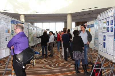 Meeting participants meander through the rows of posters at the 2015 Joint User Facility and PI Science Team Meeting.
