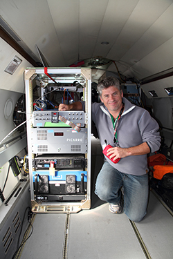 ARM-ACME V Principal Investigator Sébastien Biraud in the cabin of the G-1 aircraft next to the greenhouse-gas-monitoring instruments. Image courtesy of John Hubbe, AAF Payload Director.
