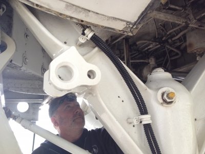 Lead mechanic Mike Crocker is greasing joints inside the langing gear system - part of the routine maintenance procedures.