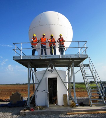 Workers at the Southern Great Plains finalize the installation of the first of three X-band scanning ARM precipitation radars.