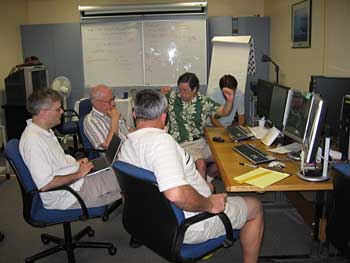 In mission control, the TWP-ICE science team discusses where in the clouds to safely send the aircraft for collecting in situ data of interest.