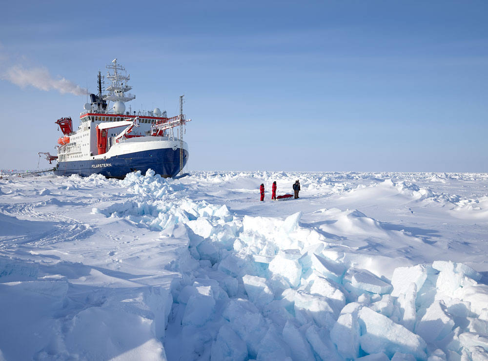 Polarstern drifting in the arctic ice with scientists in the front on the right side