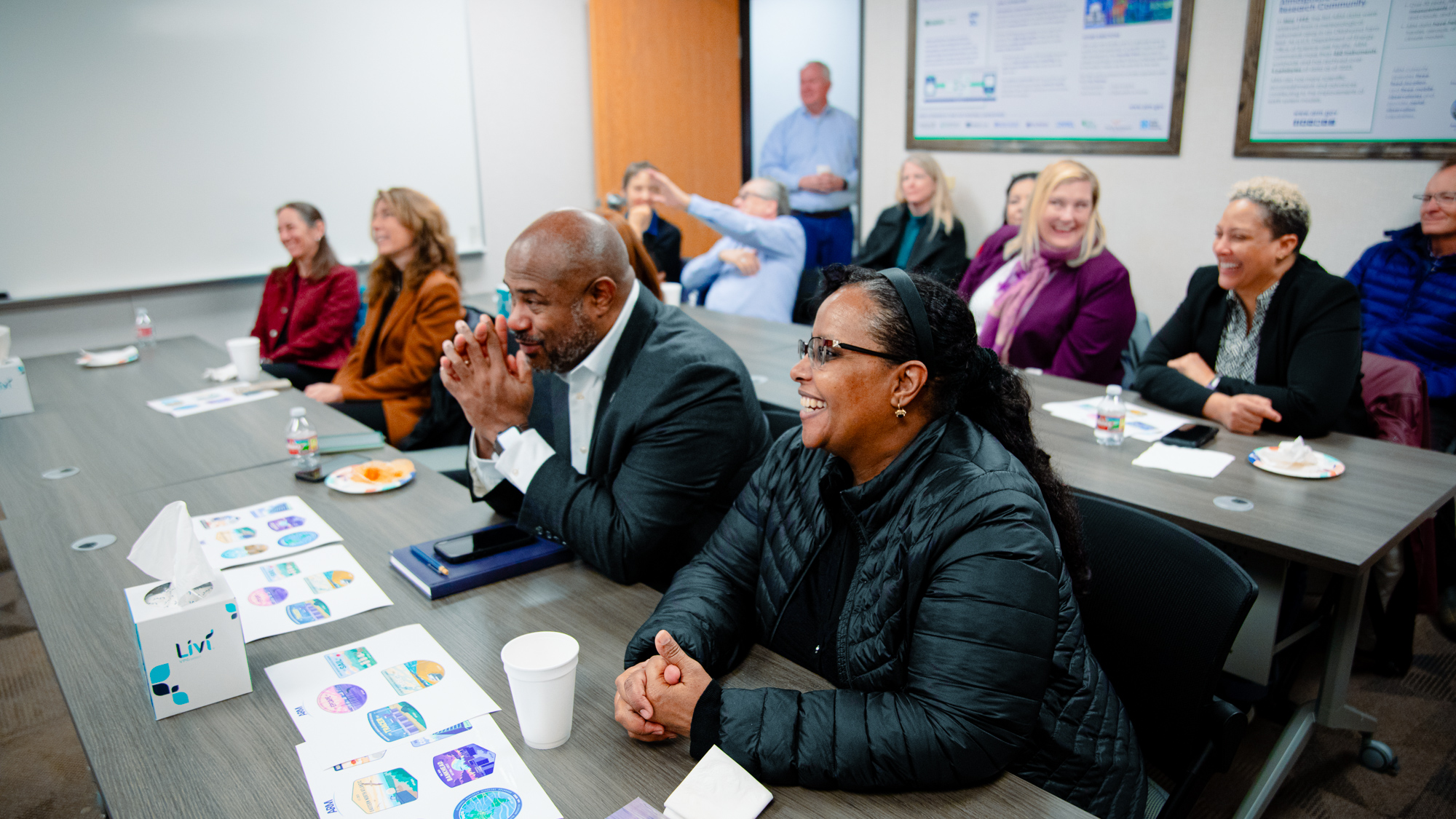 Visitors gather in conference room