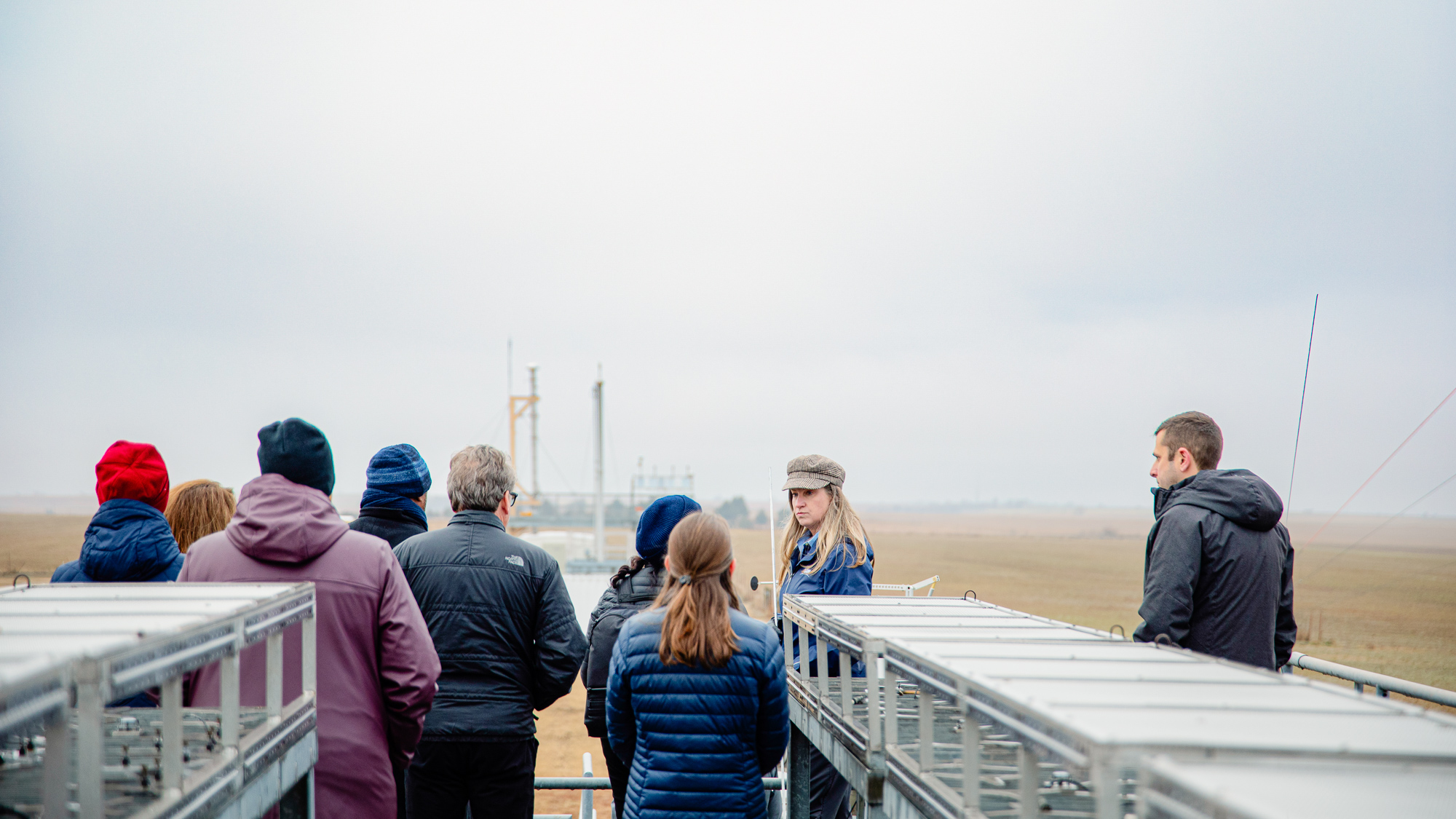 Visitors stand on top of a facility building.