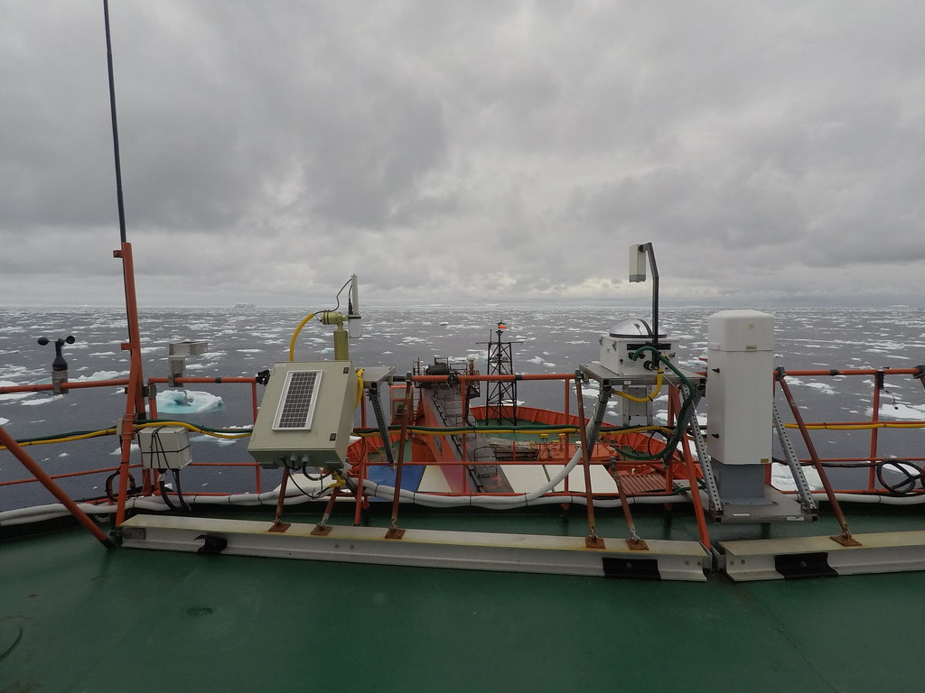 Ice chunks float in the Southern Ocean as ARM instruments collect data from a ship deck.
