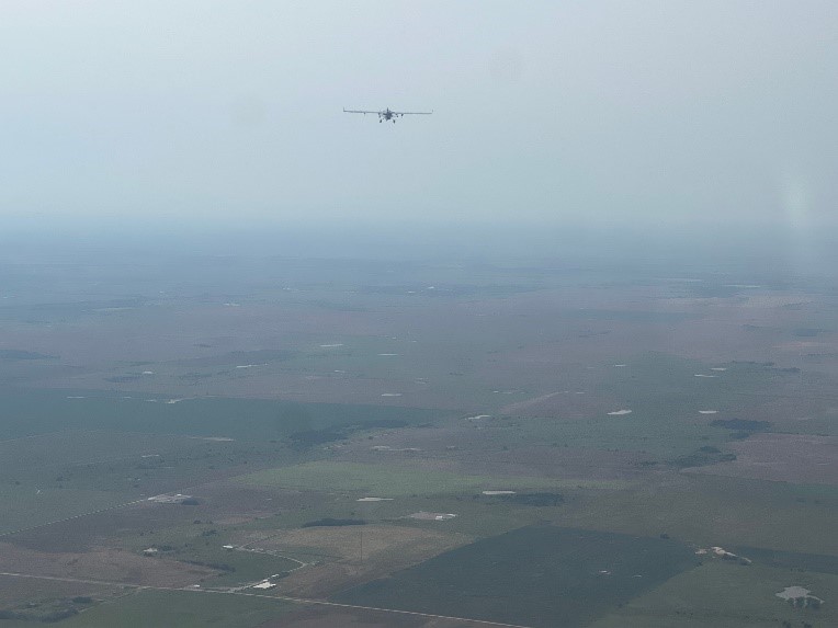 The ArcticShark flies over ARM's Southern Great Plains atmospheric observatory, as photographed from a chase plane tasked with maintaining visual contact with the aircraft.