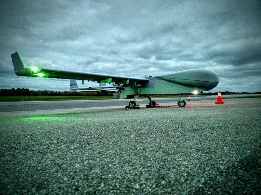 ARM's ArcticShark uncrewed aerial system sits on the tarmac on a cloudy day.