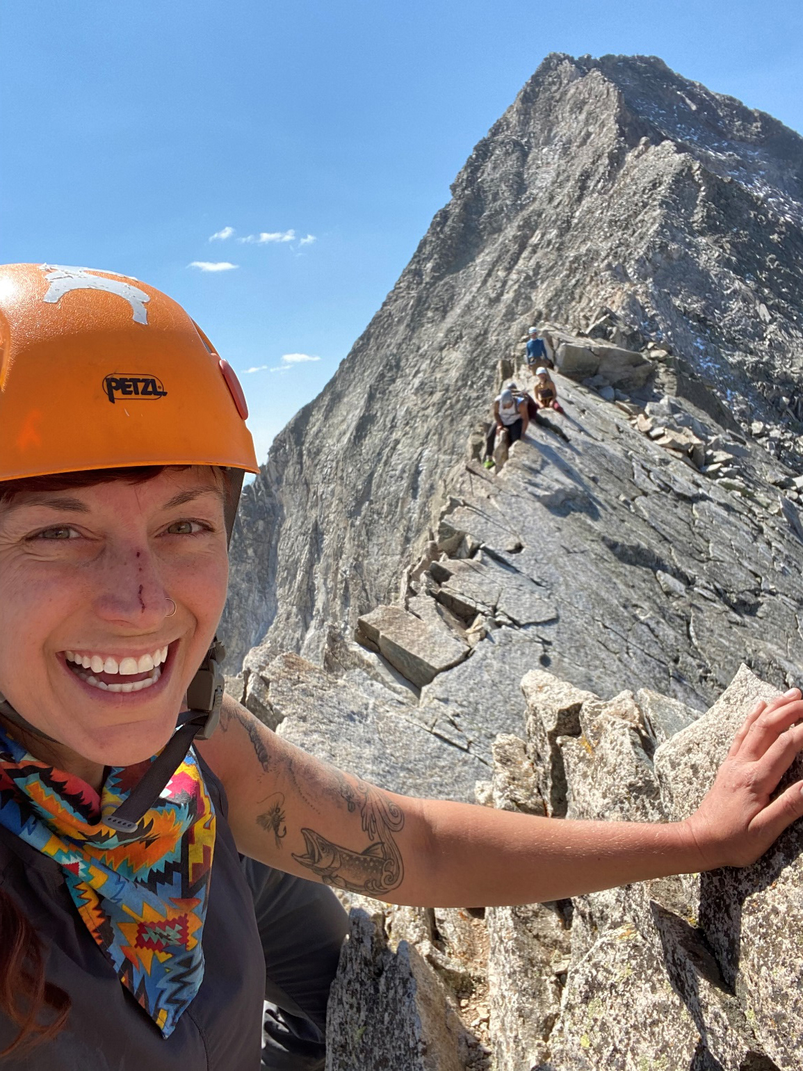 Jessie Creamean climbs Capitol Peak in Colorado wearing an orange helmet.