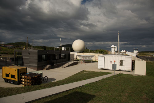A wide view of the Eastern North Atlantic observatory with dark low clouds overhead