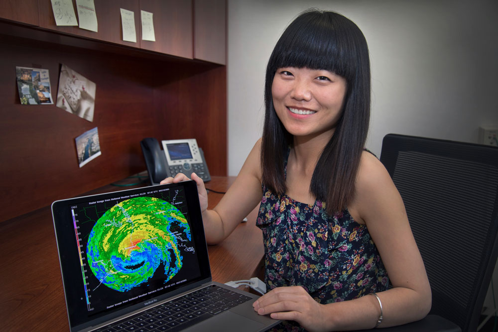 Dié Wang positions her computer to show a radar image from southeastern Texas.