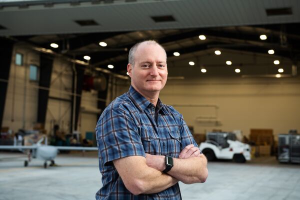 Tim McLain, who oversees flight operations for the ARM Aerial Facility, stands outside a hangar.