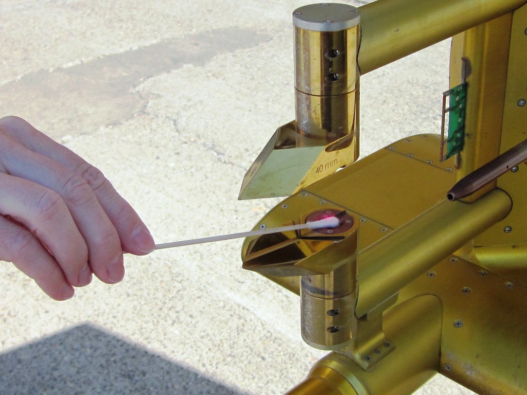 Person applies a swab to an aircraft probe