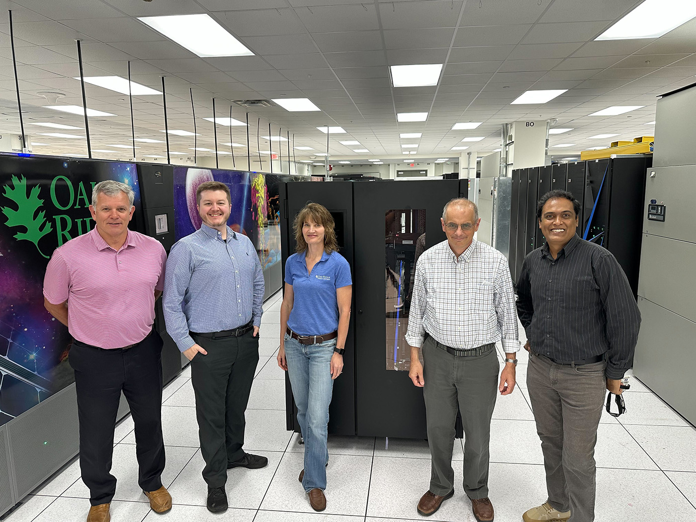 This May 2023 photo shows ARM and Oak Ridge National Laboratory staff standing next to or in front of ARM’s current and future deep archival systems. 