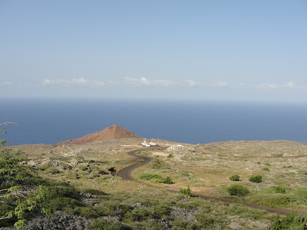 Road leads down to ARM Mobile Facility on Ascension Island, with the ocean behind it and clouds on the horizon
