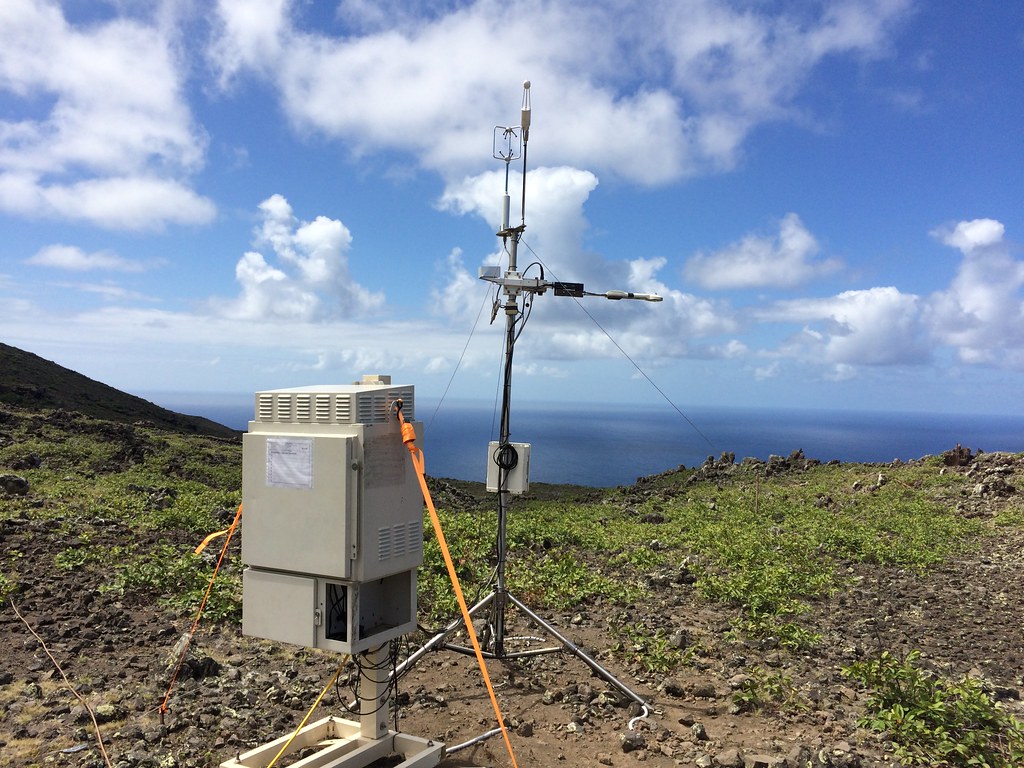 Instruments on Ascension Island with the ocean and a cloudy sky behind them