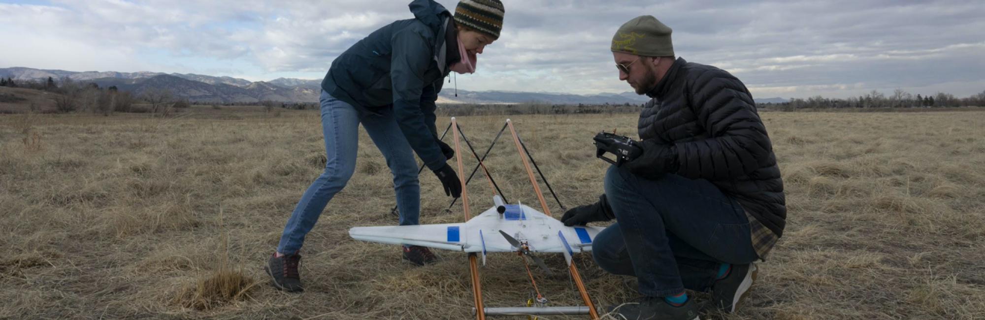 CIRES postdoctoral researcher Radiance Calmer (left) and Colorado University (CU) Boulder engineering graduate student Jonathan Hamilton place an unmanned aerial system on its launcher in preparation for its first test flight in Boulder, Colorado. It’s the same kind they are using on the MOSAiC expedition to gather atmospheric data on temperature, pressure and humidity. Photo by Julia Medeiros.