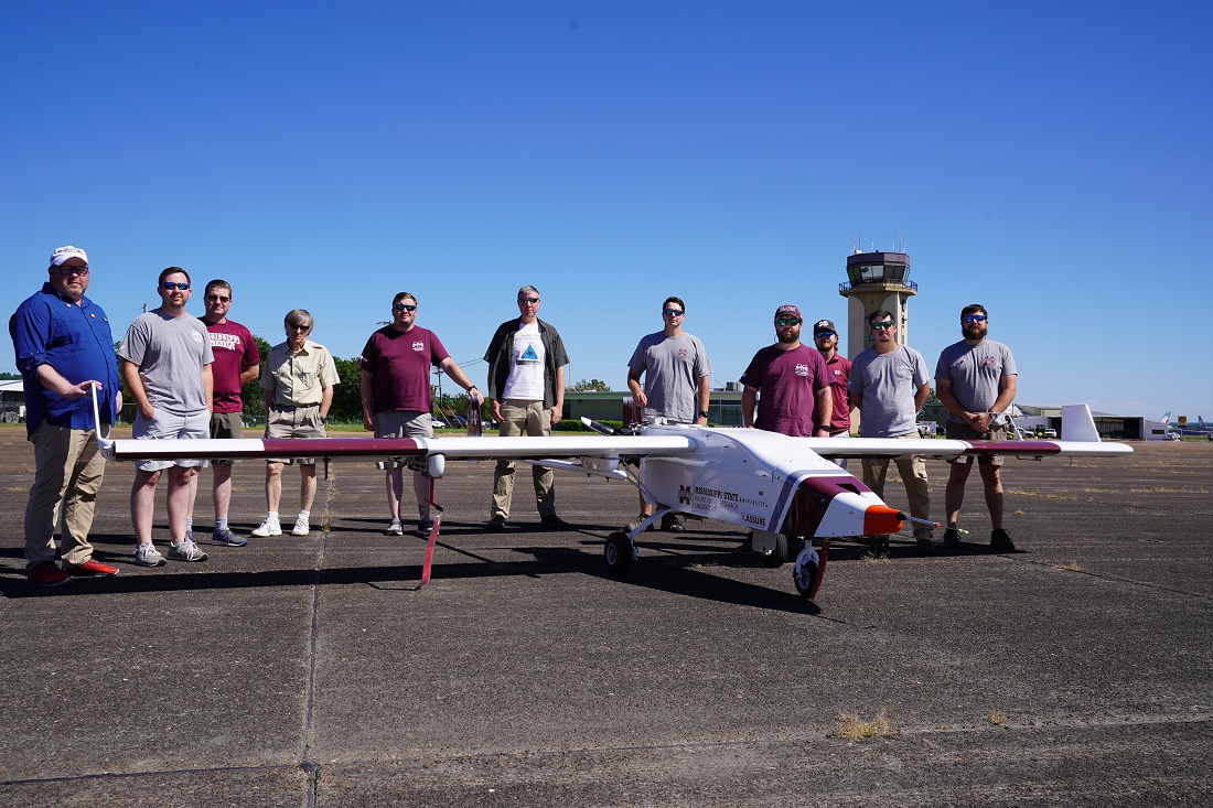 ARM and Raspet Flight Research Laboratory teams pose with the TigerShark XP uncrewed aerial system