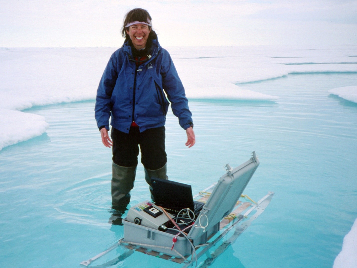 Bonnie Light stands in a melt pond during SHEBA field campaign in the Arctic