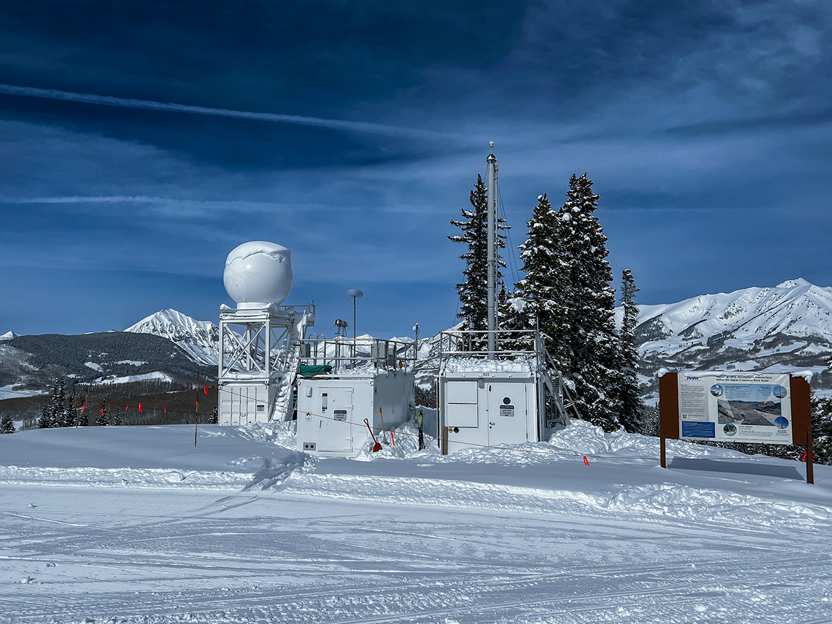 An X-band radar sits next to ARM's Aerosol Observing System on snow-covered Crested Butte Mountain.