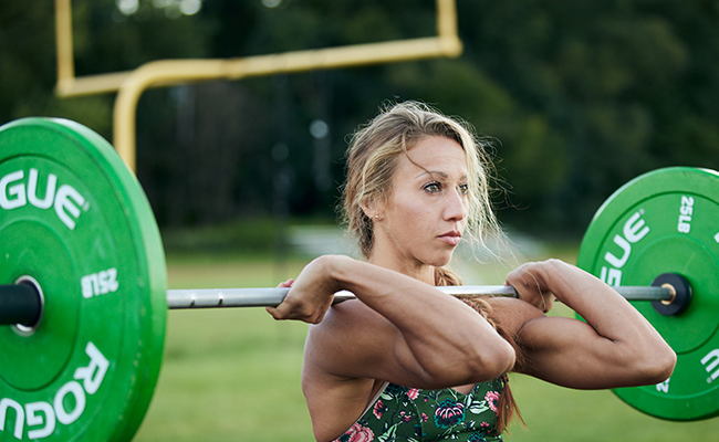 Kara Sulia lifts a barbell while exercising