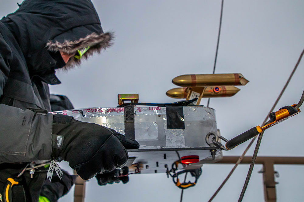 A tethered balloon team member works with the Gondola guest instrument platform