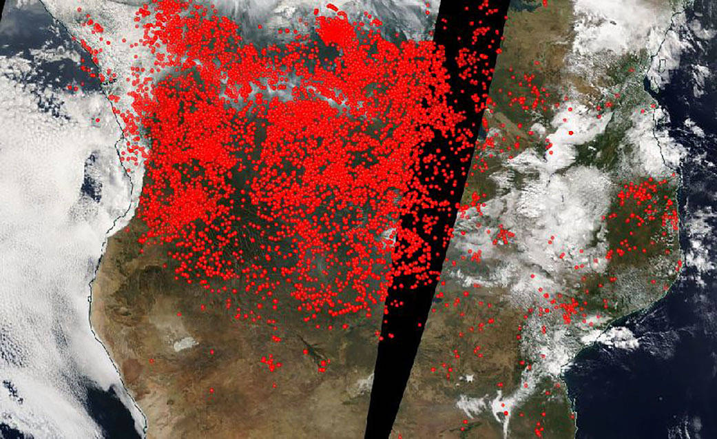 A satellite map with red dots indicating fire locations in Africa