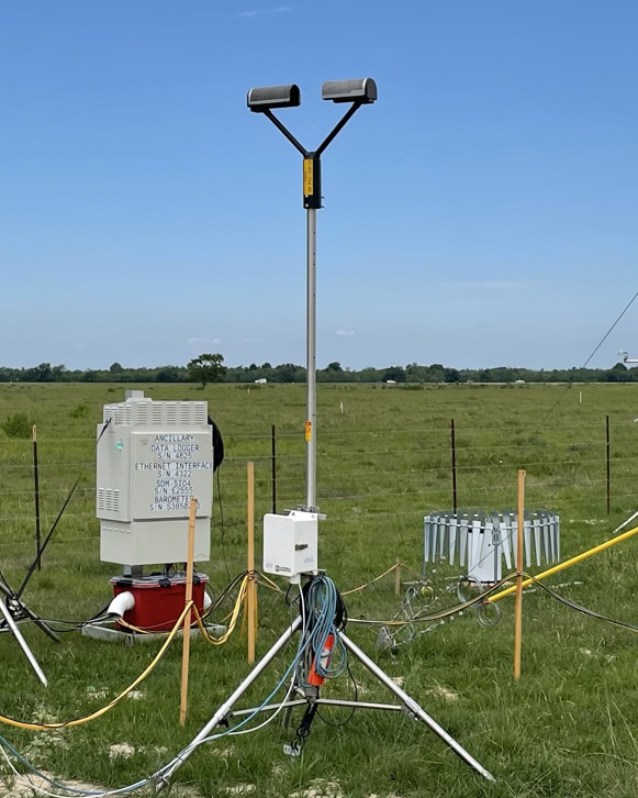 ARM installed a laser disdrometer, a rain gauge, and a data logger system in a field in Guy, Texas.