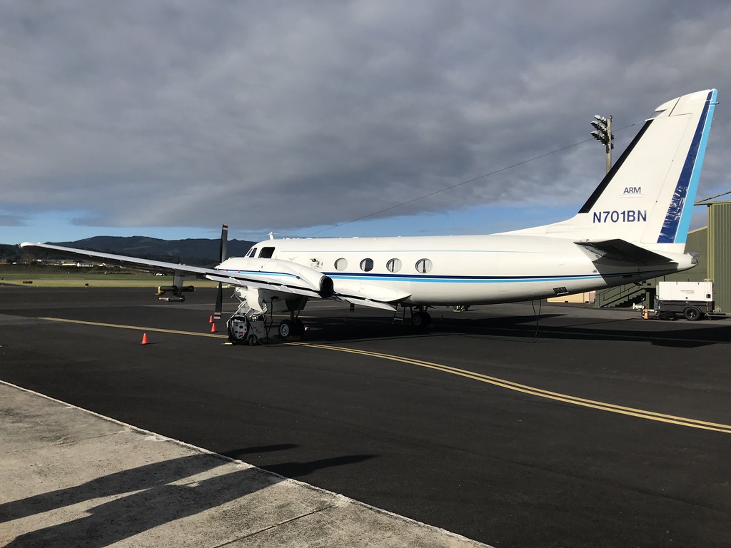 A plane sits on a tarmac underneath low clouds with blue sky in the distance. ARM file photo.