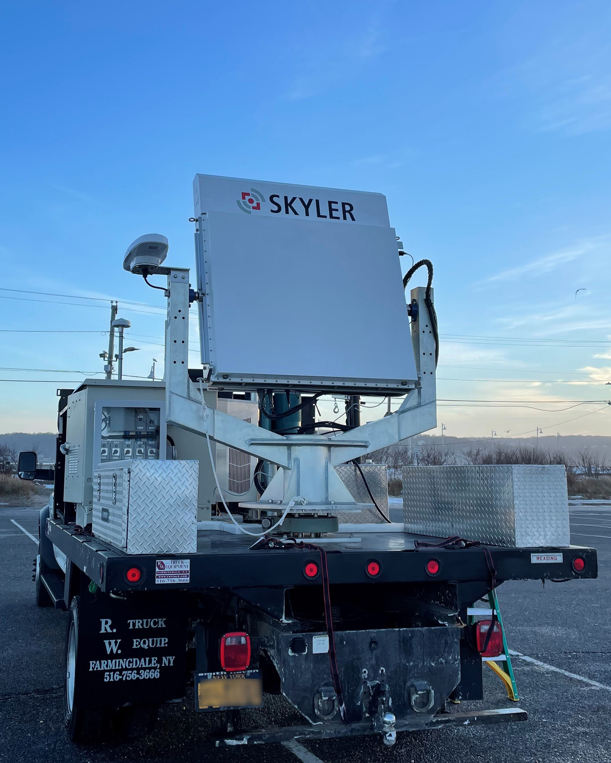 An X-band radar sits on the back on a truck ready for use.