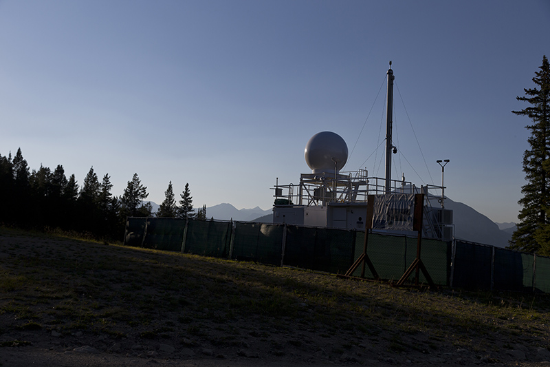 Haze is visible in the distance as the Colorado State University X-band precipitation radar and ARM Aerosol Observing System operate on Crested Butte Mountain.