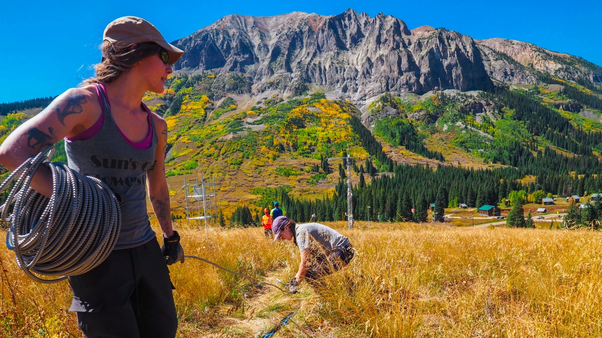 On a sunny day, Anna Hodshire looks over her left shoulder while doing fieldwork in Colorado.